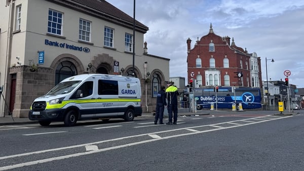 Garda van with a garda and bollards at the site of a road collision
