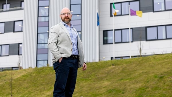 Image of a business man pictured outside an office building