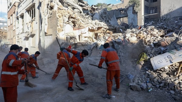 Iranian workers cleans at the site of Israeli-American strikes that according to local media reports destroyed the Rafi-Nia Synagogue and nearby residential buildings in Tehran