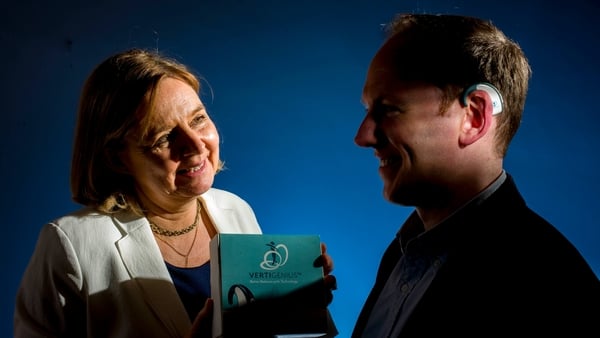 A man wearing a device on his ear that is used to treat vertigo