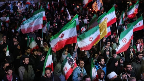 Iranians react after a ceasefire announcement at the Enqelab square, in Tehran on 8 April