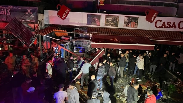 First responders gather at the site of an Israeli airstrike that targeted a vehicle in Saida, Lebanon