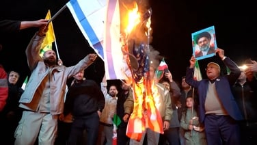 People burn US and Israeli flags in Tehran