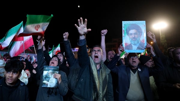 Iranians react after a ceasefire announcement at the Enqelab square, in Tehran, on April 8