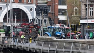 tractors are seen across a bridge