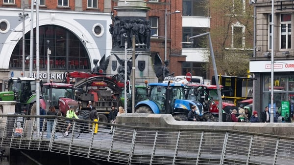 tractors are seen across a bridge