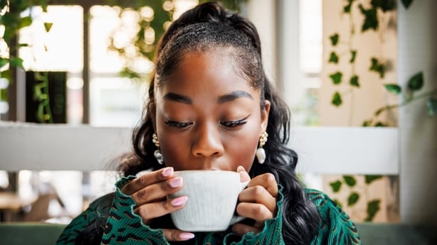 woman drinking a cup of coffee