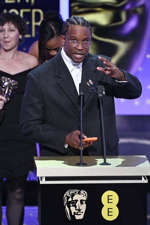 Akinola Davies Jr. accepts the Outstanding Debut by a British Writer, Director or Producer Award for 'My Father's Shadow' at the 2026 BAFTA Awards