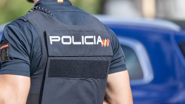 MNational Police officer. Spanish policeman dressed in uniform and with a bulletproof vest. Close-up of the national policeman from behind