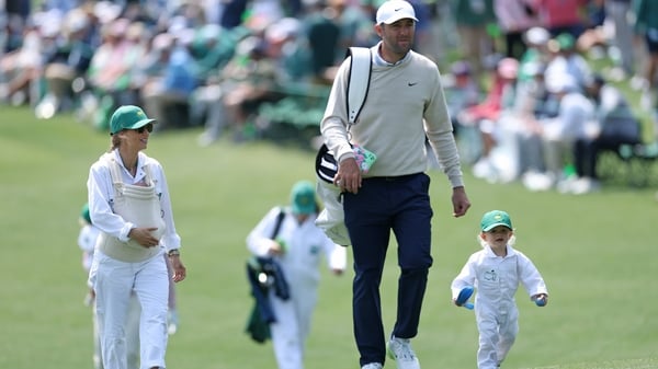 AUGUSTA, GEORGIA - APRIL 08: Scottie Scheffler of the United States walks with his son Bennett alongside his wife Meredith who is holding baby Remy during the Par Three Contest prior to the 2026 Masters Tournament at Augusta National Golf Club on April 08