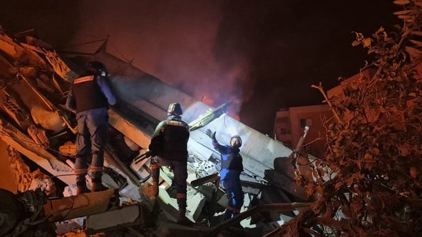 First responders search under the rubble at the site of an Israeli airstrike in the village of Habbouch, southern Lebanon