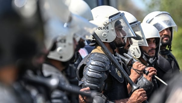 Riot policemen line up along a road near the expected venue of the US-Iran talks in the Red Zone area of Islamabad