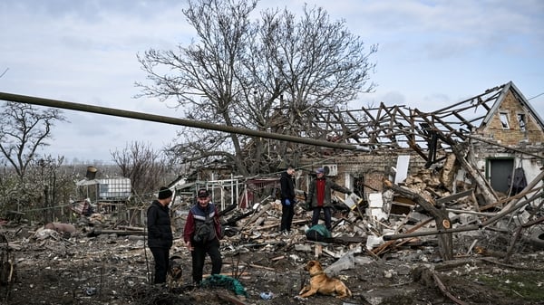 People work at the site of a Russian KAB strike in Balabyne, Zaporizhzhia region, Ukraine