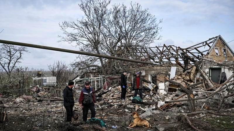 People work at the site of a Russian KAB strike in Balabyne, Zaporizhzhia region, Ukraine