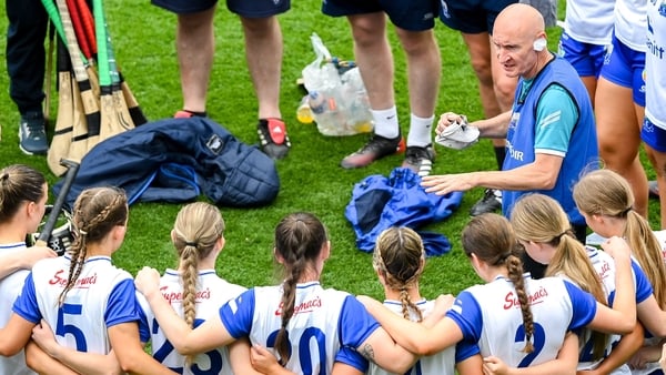Waterford manager Michael Boland speaks to his players and staff from inside their huddle during the Glen Dimplex Senior All-Ireland Camogie Championship quarter-final match between Clare and Waterford at Croke Park in Dublin.