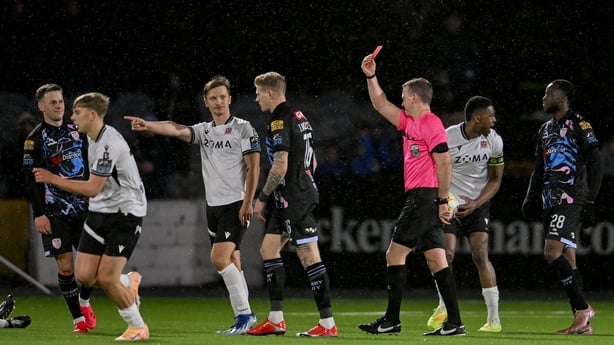 Referee Paul Norton gives James McClean of Derry City a red card (after a second yellow) against Dundalk - April 2026