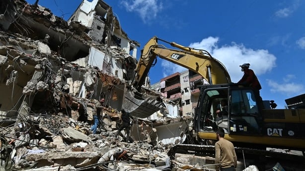 This photograph taken on April 10, 2026, during a media tour organized by Hezbollah's media office shows a digger clearing the rubble of a building in Beirut's Hay al-Selloum neighbourhood, that was targetted in an Israeli strike earlier this week. The Israeli military said on April 10 that it had "