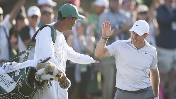 Rory McIlroy of Northern Ireland and his caddie Harry Diamond react on the 17th green during the second round of the 2026 Masters Tournament at Augusta National Golf Club on April 10, 2026 in Augusta, Georgia.