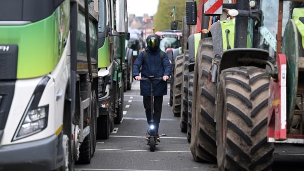 DUBLIN, IRELAND - APRIL 11: Members of the public make their way past trucks and tractors as fuel protestors block O'Connell street on April 11, 2026 in Dublin, Ireland. Travel across parts of the Republic of Ireland is affected for the fifth day in a row
