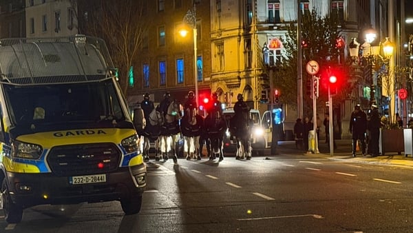 A garda van and gardaí on horseback on O Connell Bridge.