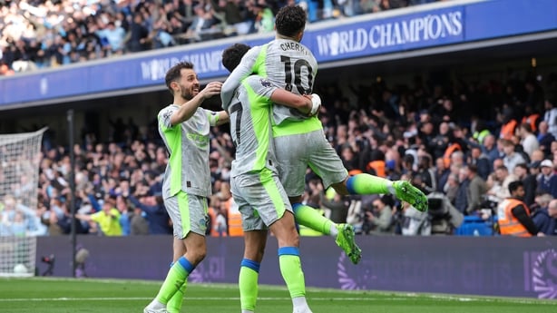 Rayan Cherki of Manchester City celebrates with Matheus Nunes and Bernardo Silva after Marc Guehi (not pictured) scores their second goal during the Premier League match between Chelsea and Manchester City at Stamford Bridge on April 12, 2026 in London, England.
