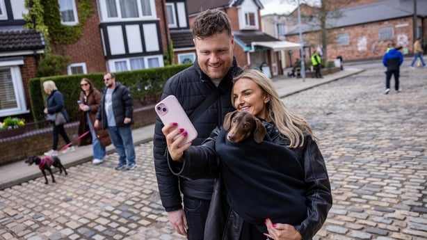 Ryan Mason and Danielle Roche with their dog, Max, on the Coronation Street cobbles in Manchester. Photo: James Speakman/PA Media Assignments 