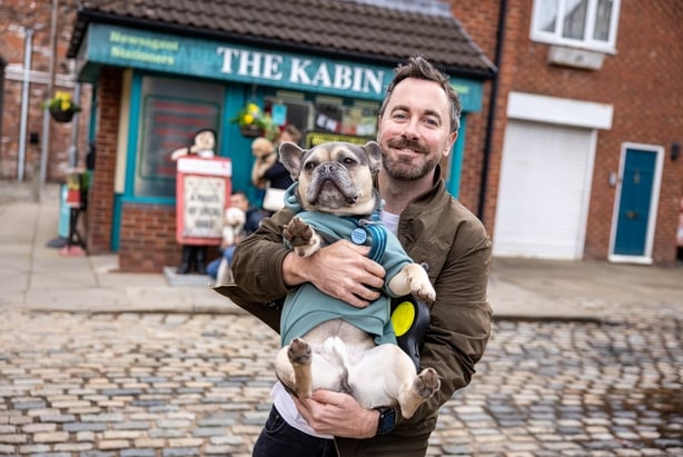 Brad Wood and Bobby, a French Bulldog, on the Coronation Street cobbles in Manchester. Photo: James Speakman/PA Media Assignments