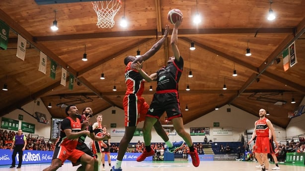 Killester's Farouq Raheem challenges Joshua Steel of Ballincollig
