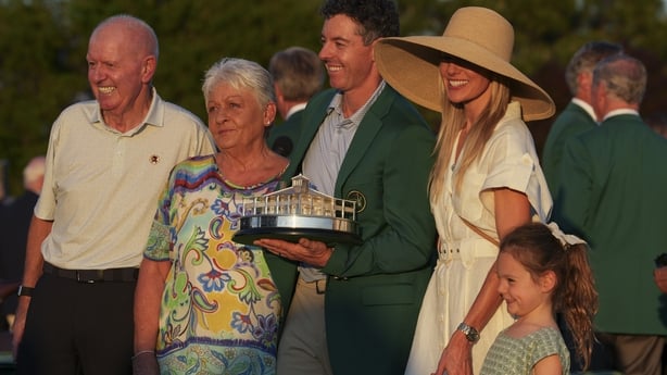 AUGUSTA, GEORGIA - APRIL 12: Rory McIlroy of Northern Ireland holds the trophy wearing his Green Jacket with his family his father Gerry McIlroy, his mother Rosie McIlroy his wife Erica and his daughter Poppy at the presentation after the final round of Masters Tournament at Augusta National Golf Cl