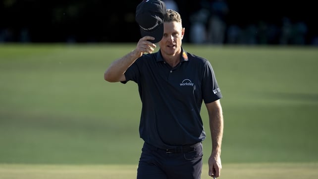 Justin Rose of England tips his hat on the 18th green at the masters