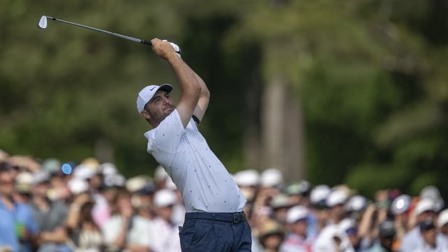 Scottie Scheffler plays a stroke from the No. 12 tee during the final round of the Masters