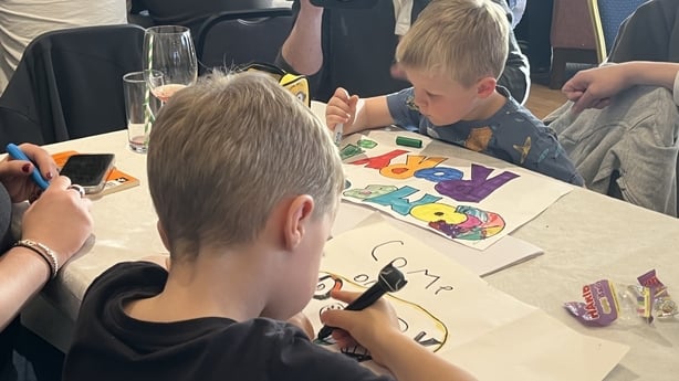 children colour in signs celebrating Rory McIlroy