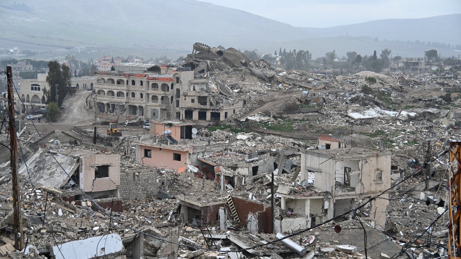 Israel says troops fighting Hezbollah surrounded town