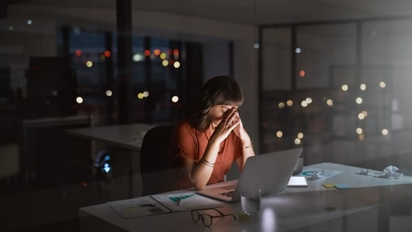 Shot of a young businesswoman looking stressed out while working on a laptop in an office at night (Getty Images)