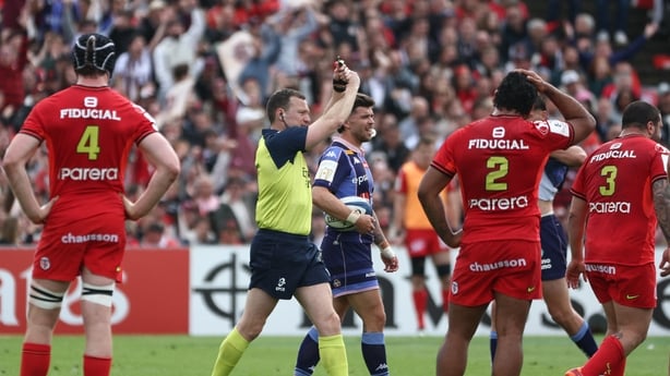 Referee Matthew Carley (C) shows a red card to Toulouse prop Dorian Aldegheri (R) in Champions Cup quarter-final against Bordeaux - April 2026