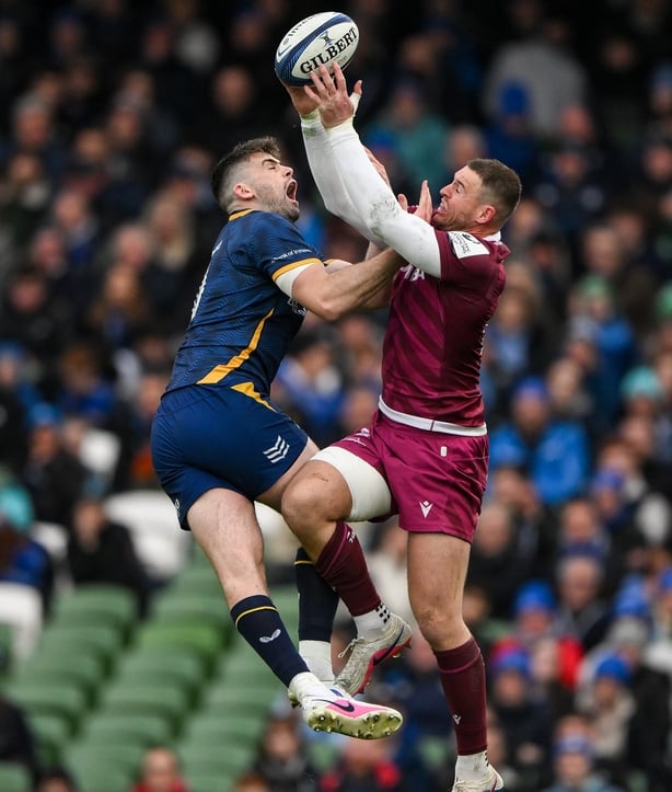 11 April 2026; Harry Byrne of Leinster, left, and Tom Roebuck of Sale Sharks contest a high ball during the Investec Champions Cup quarter-final match between Leinster and Sale Sharks at the Aviva Stadium in Dublin. Photo by Brendan Moran/Sportsfile