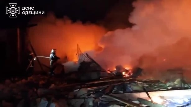 a firefighter is seen working at the scene of a large blaze