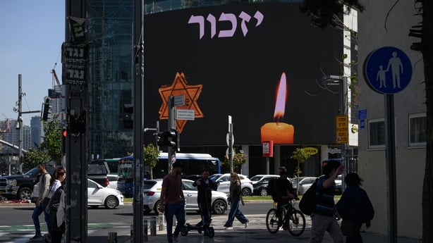 Traffic and people stop to observe a two minute siren to mark Yom HaShoah at Azrieli junction in Tel Aviv
