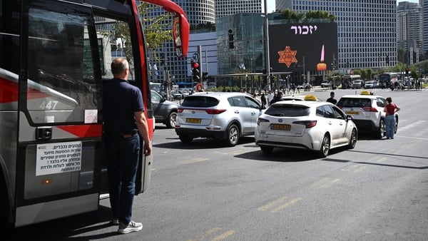 Traffic and people stop to observe a two minute siren to mark Yom HaShoah at Azrieli junction in Tel Aviv