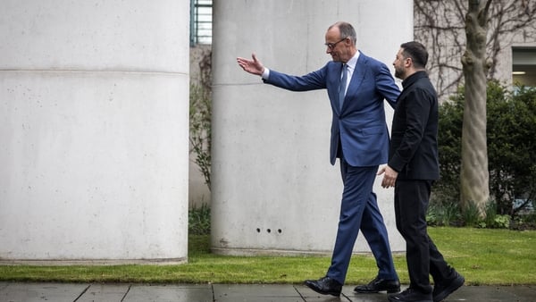 BERLIN, GERMANY - APRIL 14: German Chancellor Friedrich Merz and Ukrainian President Volodymyr Zelensky walk before reviewing a military guard of honour upon Zelensky's arrival at the Chancellery on April 14, 2026 in Berlin, Germany. The German and Ukrain