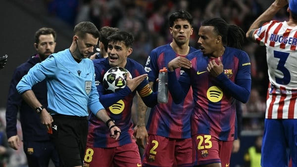 Barcelona players argue after the referee gave a red card to Barcelona's Spanish defender #24 Eric Garcia during the UEFA Champions League quarter final second leg football match between Club Atletico de Madrid and FC Barcelona at Metropolitano Stadium in