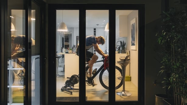 man on an exercise bike at home