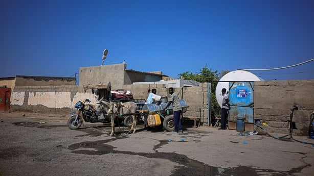 A Sudanese water vendor fills the tank of a donkey-drawn cart at the water station in Port Sudan
