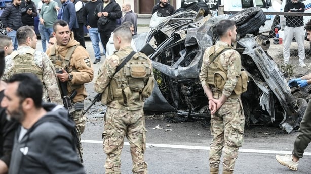 Security forces secure the site of an Israeli airstrike that targeted a vehicle the Lebanese town of Jiyeh, south of Beirut,