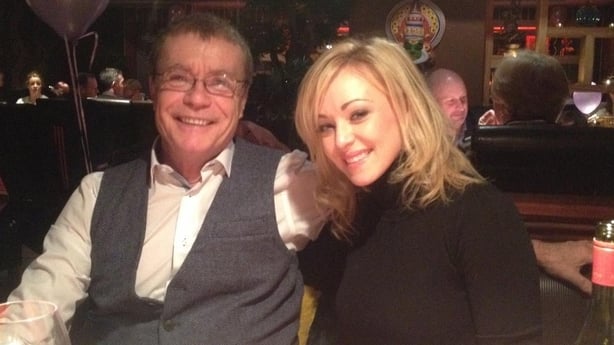 Lisa Marie Maher and her father, Eugene, sit at a table.