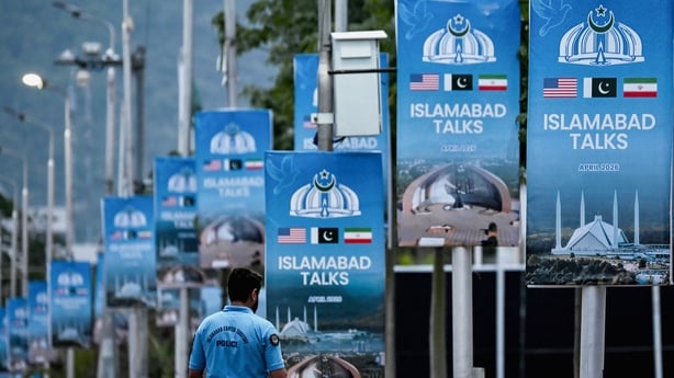 rows of banners with the words 'islamabad talks' on them attached to poles