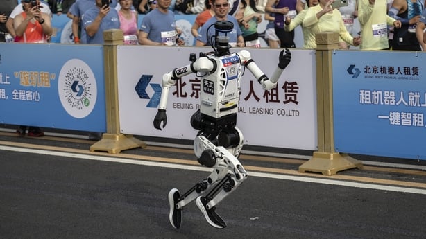 A humanoid robot runs in a race