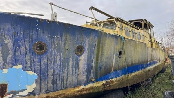 a rusted out boat in a dry dock