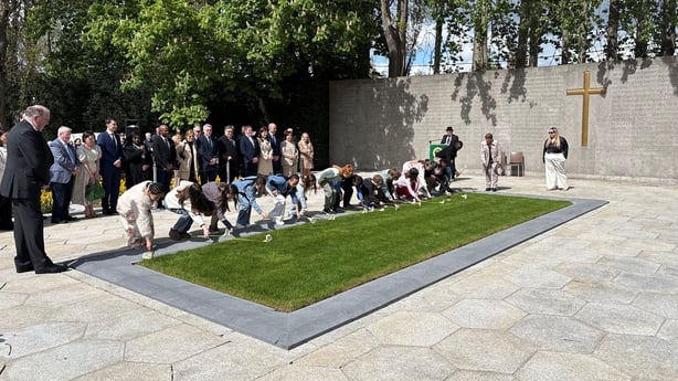 School children lay lilies on the graves of the leaders of the Easter Rising during Fianna Fail's annual 1916 Easter Rising commemoration at Arbour Hill Cemetery