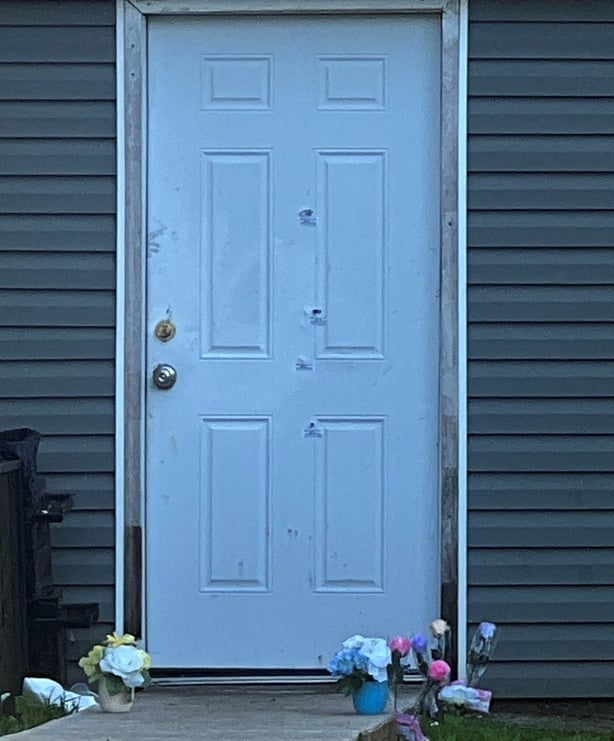 Bullet holes are seen on a door of the house where a mass shooting took place in Shreveport, Louisiana, on April 19, 2026. Eight children were killed in a shooting spree early April 19 in the southern US state of Louisiana, in what police said appears to have been an incident of domestic violence. T
